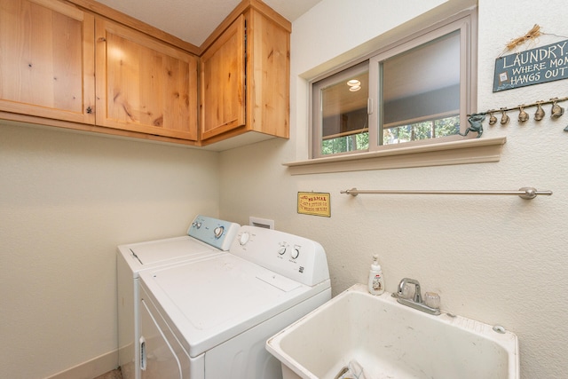 washroom featuring washer and clothes dryer, cabinets, and sink