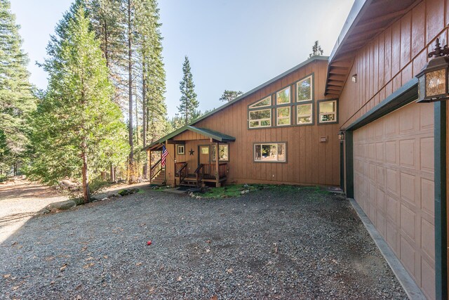 rear view of house featuring a garage