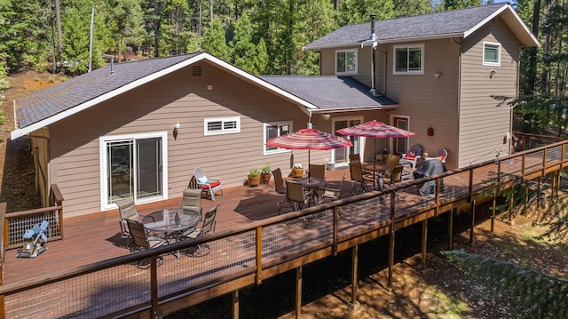 back of house featuring an outdoor fire pit and a wooden deck