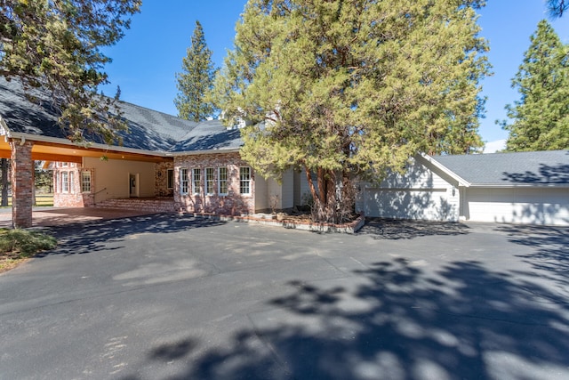 view of front facade with a patio area and a garage