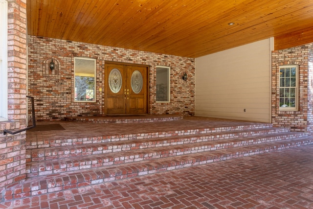 view of exterior entry with covered porch