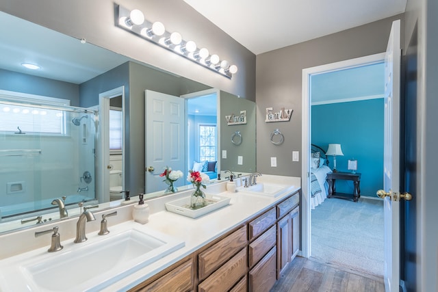 full bathroom with dual vanity, toilet, bathtub / shower combination, and wood-type flooring