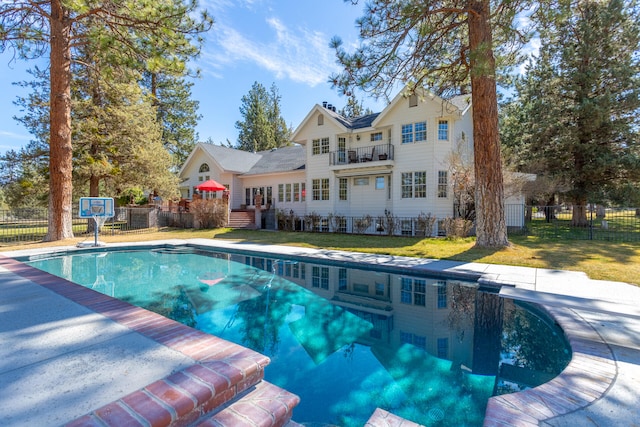 view of pool with a yard