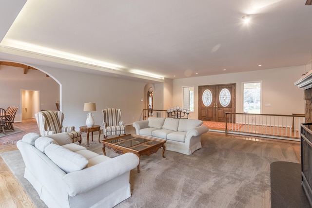 carpeted living room featuring french doors and a brick fireplace