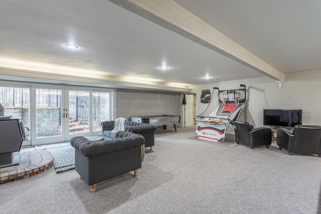 living room with light colored carpet, french doors, and beamed ceiling