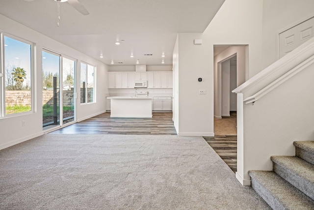 living room with dark hardwood / wood-style floors and ceiling fan