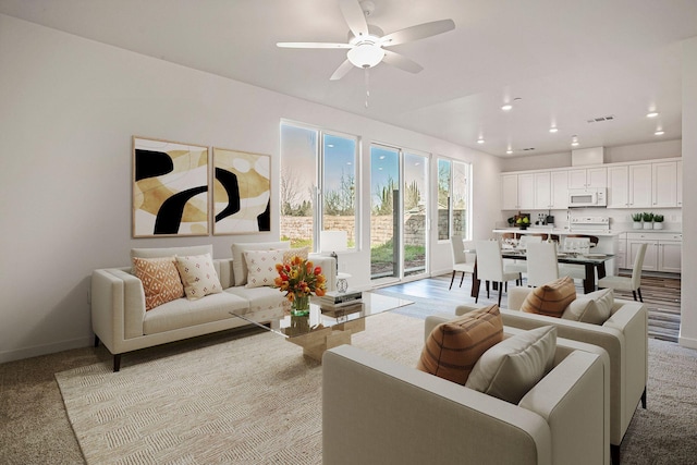 carpeted living room with ceiling fan