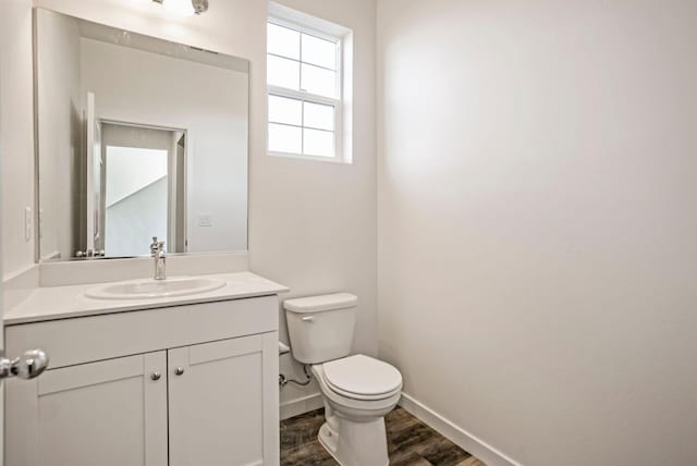 bathroom featuring hardwood / wood-style floors, toilet, and large vanity