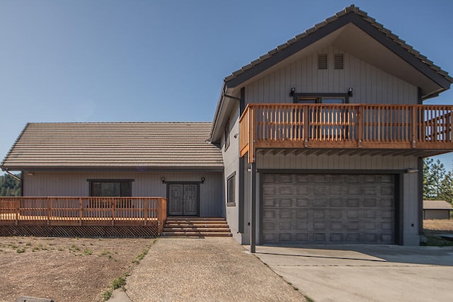 front of property featuring a deck and a garage