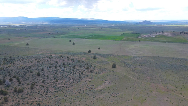 drone / aerial view featuring a mountain view and a rural view