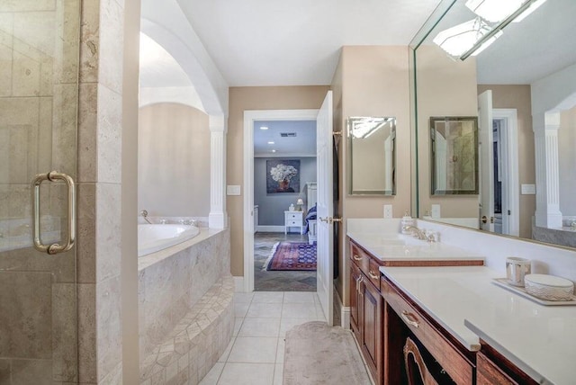 bathroom featuring plus walk in shower, large vanity, and tile floors