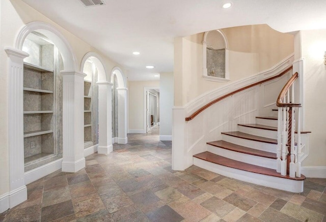 tiled entrance foyer featuring ornate columns