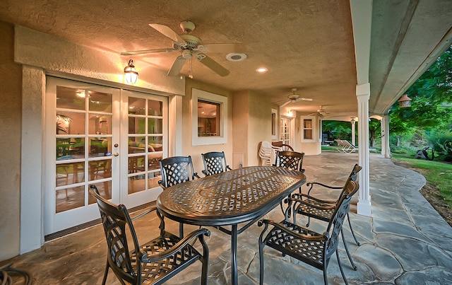 view of terrace featuring french doors and ceiling fan