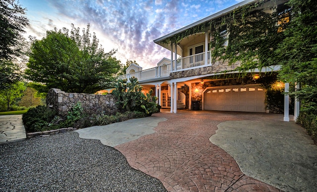 view of front of house featuring a balcony and a garage