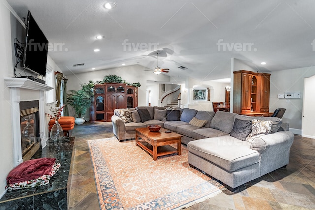 tiled living room with ceiling fan and vaulted ceiling