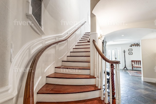 stairs featuring dark tile flooring