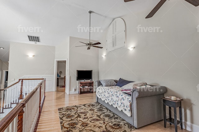 living room with lofted ceiling, light hardwood / wood-style floors, and ceiling fan