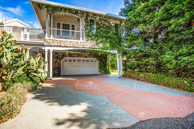 view of front of home featuring a balcony and a garage