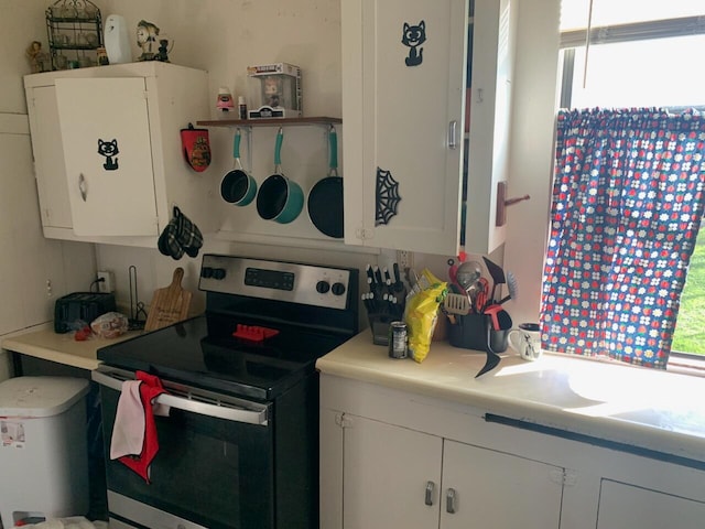 kitchen with white cabinetry and electric range