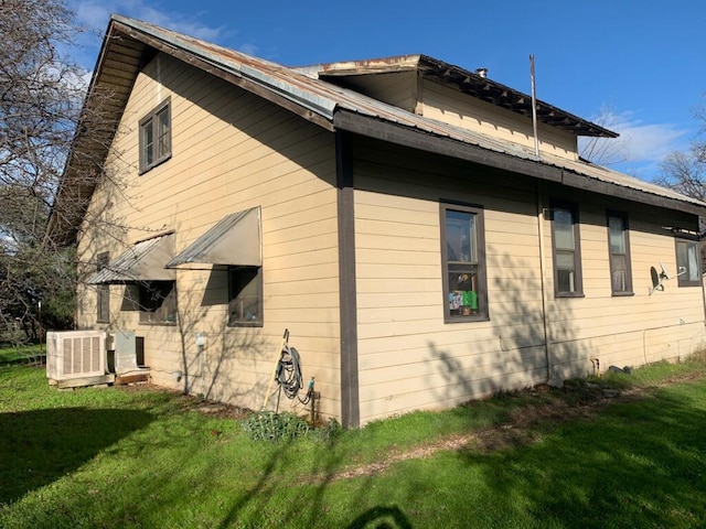 view of side of home with a yard