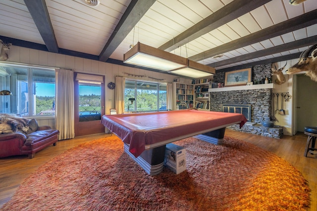 rec room featuring beamed ceiling, a fireplace, billiards, hardwood / wood-style floors, and a healthy amount of sunlight