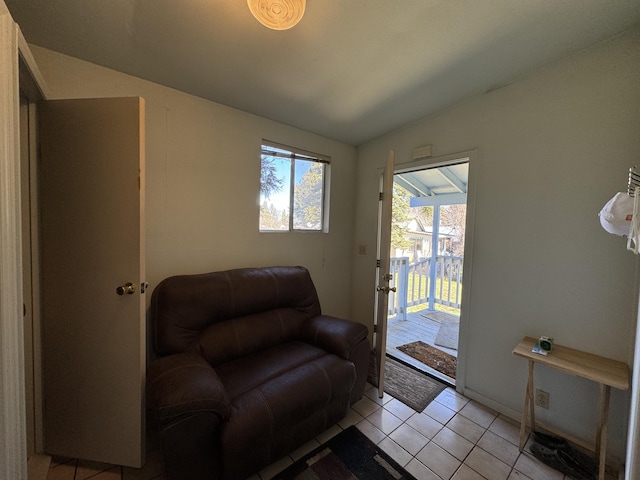 living room with lofted ceiling and light tile flooring