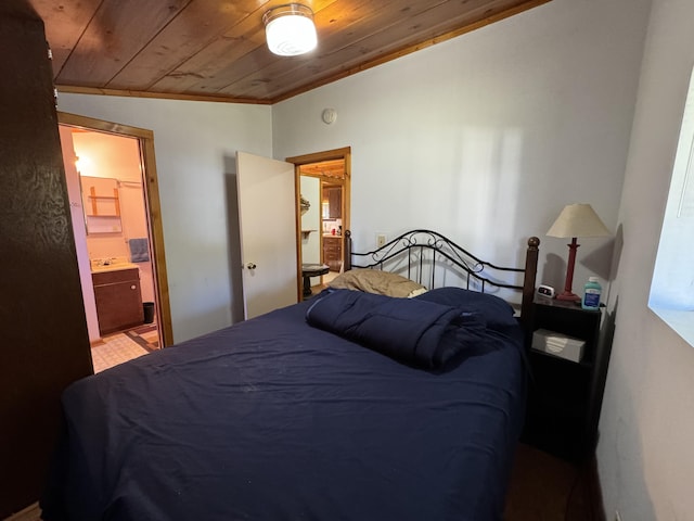 bedroom featuring lofted ceiling, wood ceiling, and ensuite bath