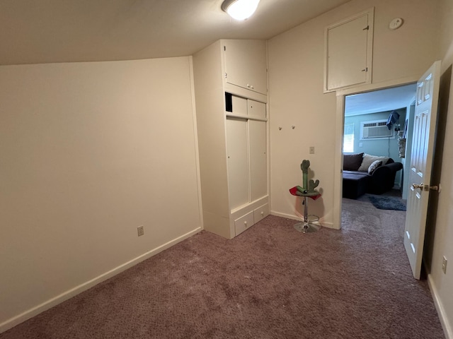 interior space with dark carpet and a wall mounted air conditioner