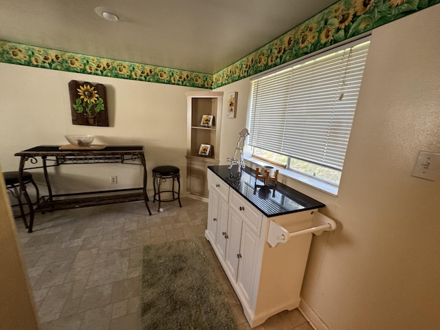 interior space with tile flooring and white cabinetry