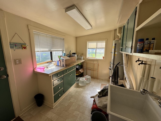 kitchen featuring sink, green cabinets, vaulted ceiling, and light tile floors