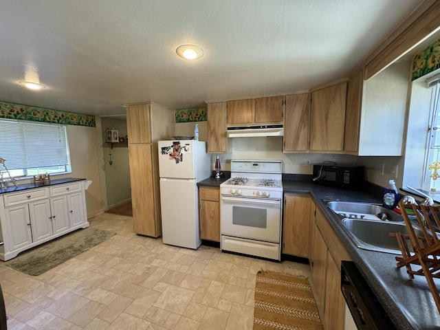 kitchen with black appliances, sink, and light tile floors