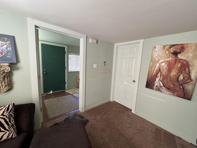 hallway featuring dark carpet