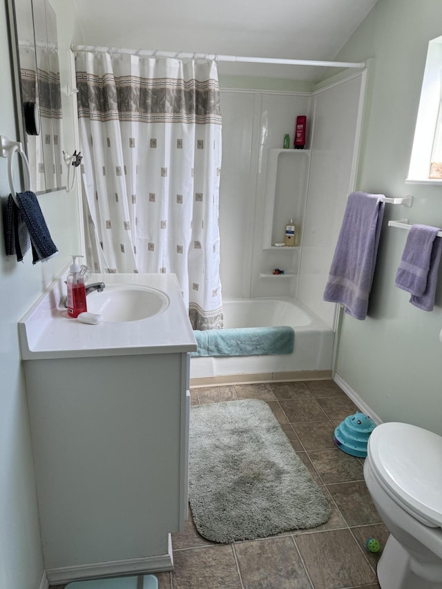 full bathroom featuring vanity, toilet, tile floors, and shower / tub combo with curtain