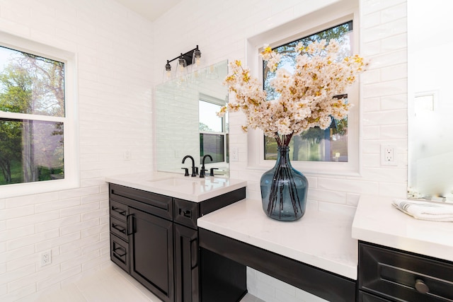 bathroom with tile walls and vanity