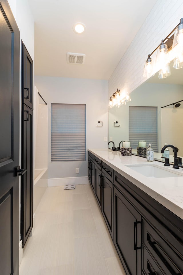 bathroom with dual vanity and tile flooring