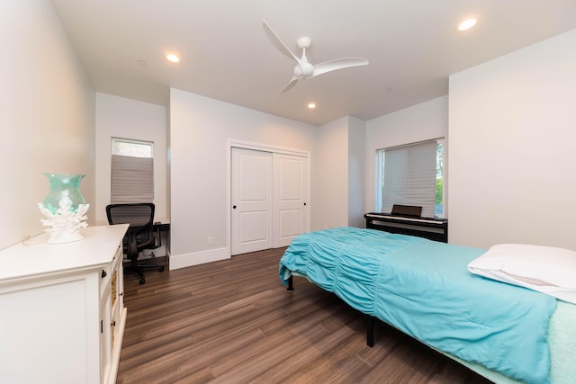 bedroom with ceiling fan, a closet, and dark wood-type flooring