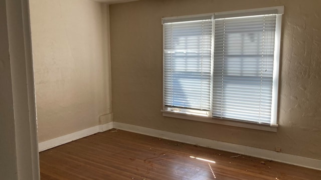 spare room with dark hardwood / wood-style flooring