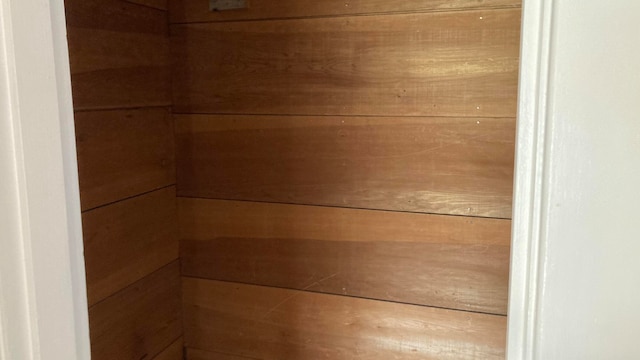 view of sauna featuring wooden walls