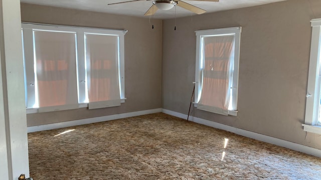 unfurnished room featuring ceiling fan and carpet flooring