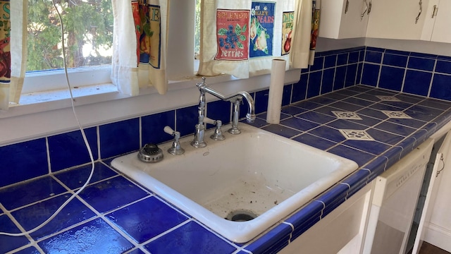 bathroom featuring sink and a relaxing tiled bath