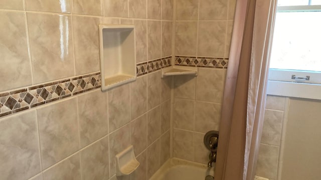 bathroom featuring tile walls, shower / tub combo with curtain, and plenty of natural light