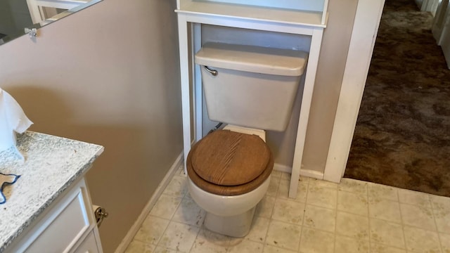 bathroom featuring tile floors, toilet, and vanity