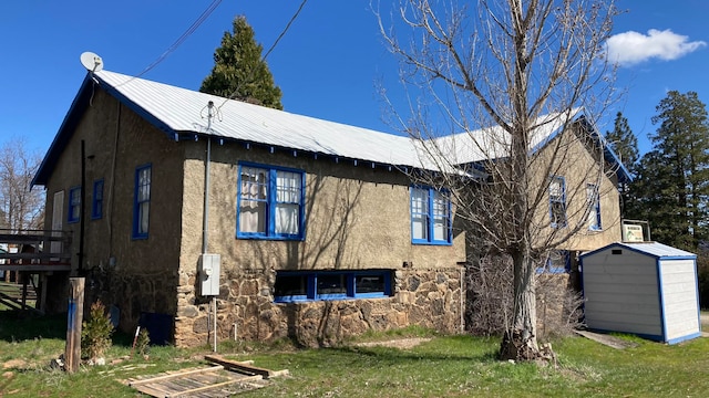 view of property exterior with a storage shed and a yard