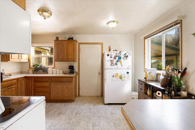 kitchen featuring white fridge and light tile flooring