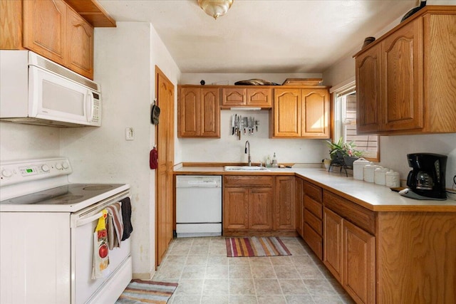 kitchen featuring light tile floors, white appliances, and sink