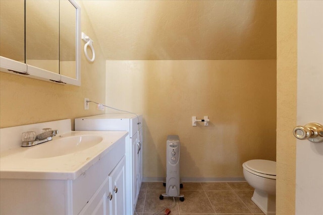 bathroom with vanity, tile floors, and toilet