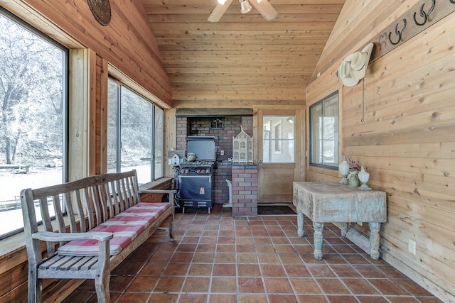 sunroom / solarium featuring lofted ceiling, a ceiling fan, and wooden ceiling