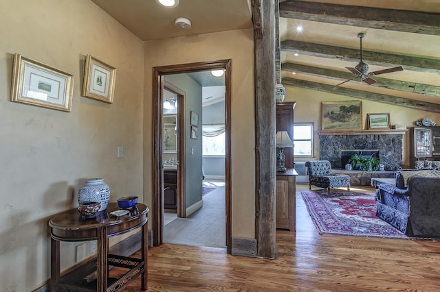 corridor with lofted ceiling with beams and wood finished floors