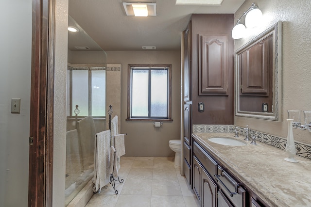 full bathroom with tile patterned floors, visible vents, toilet, a shower stall, and vanity