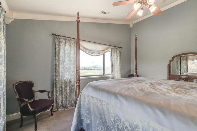 bedroom with visible vents, ceiling fan, carpet flooring, and crown molding